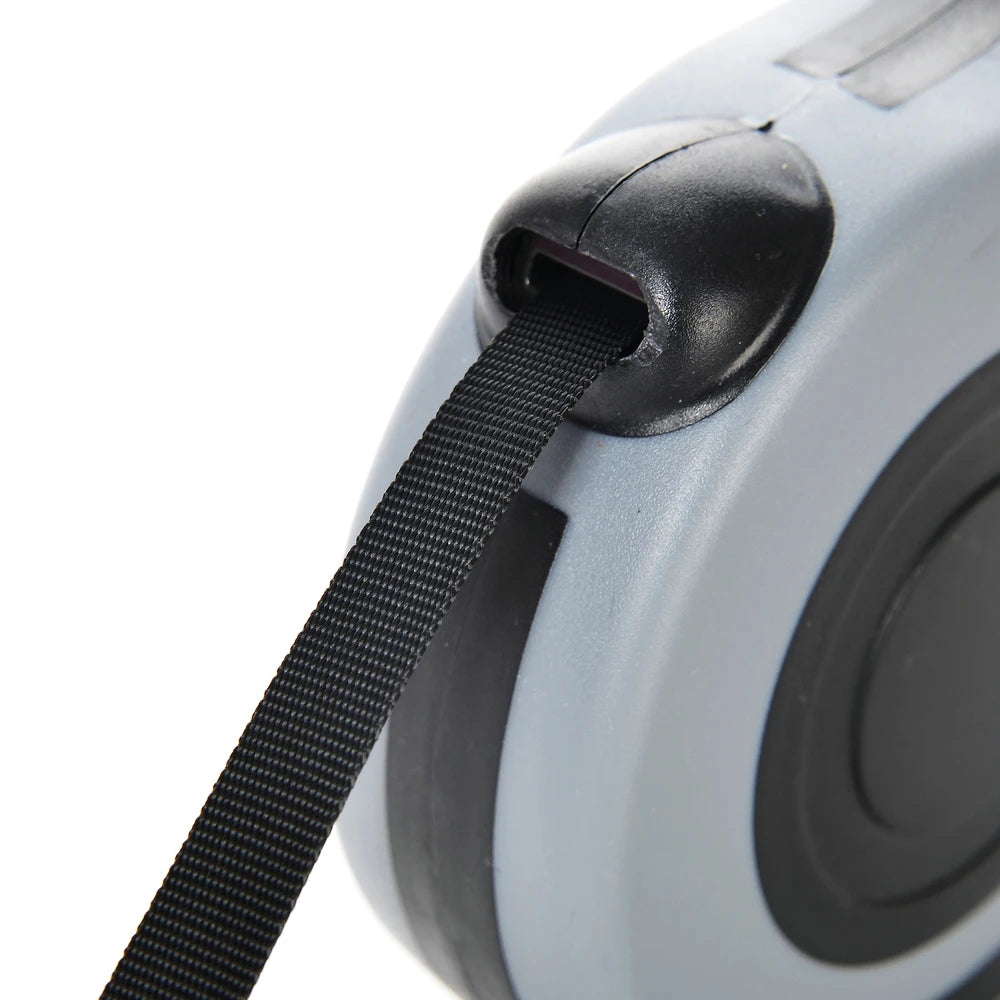 Close-up of a tape measure with black tape and gray casing on a white background
