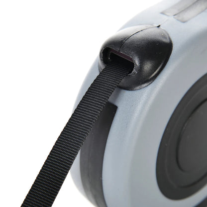 Close-up of a tape measure with black tape and gray casing on a white background