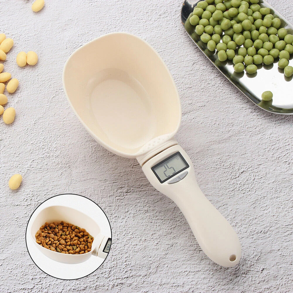 Digital measuring scoop with a digital display on a light gray surface with food items around.
