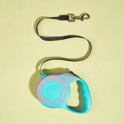 Retractable dog leash with blue handle on a yellow background
