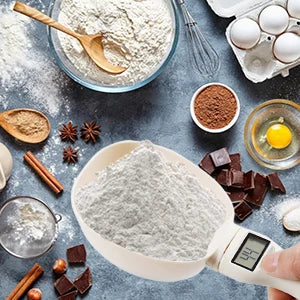 Measuring flour with a digital scale on a kitchen counter with ingredients.
