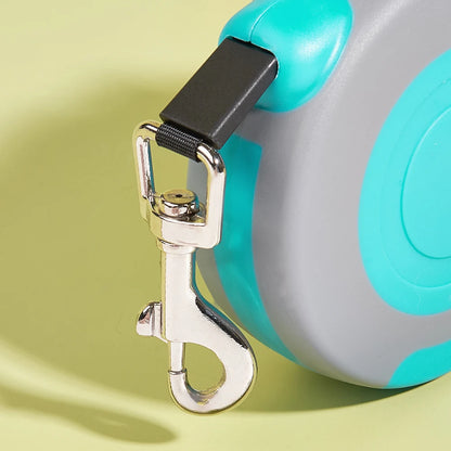 Retractable dog leash with a metal clip on a light green background