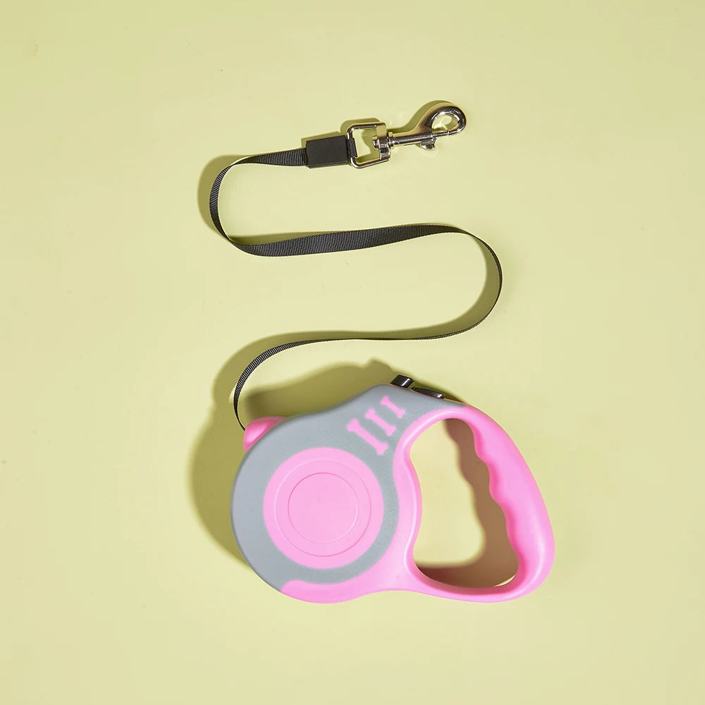 Retractable dog leash with pink handle on a light yellow background