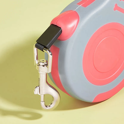 Retractable dog leash with a clip on a yellow background
