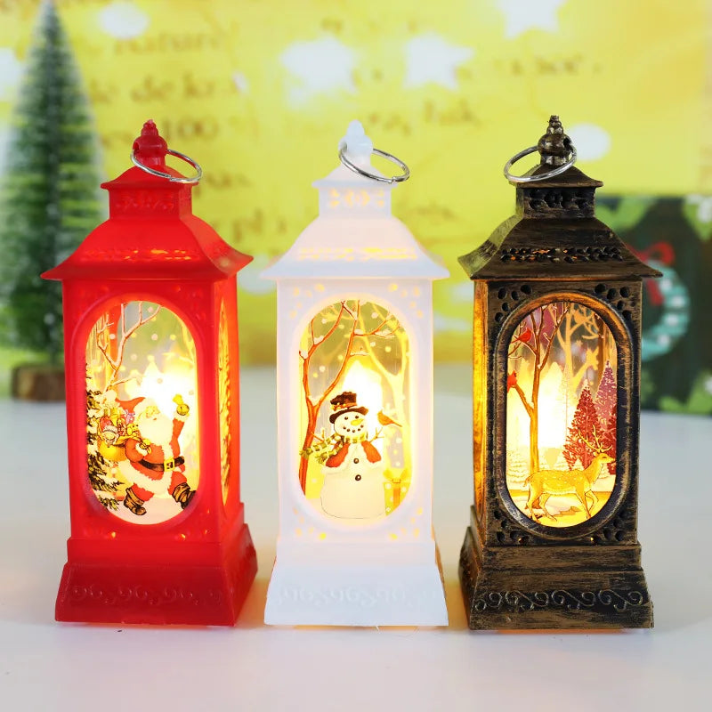 Three decorative lanterns with Christmas scenes inside, on a white surface with a blurred yellow background.