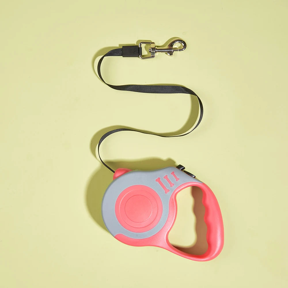 Pink and gray retractable dog leash on a yellow background