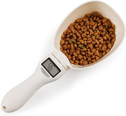 Digital pet food measuring scoop with a digital display filled with dog food on a white background
