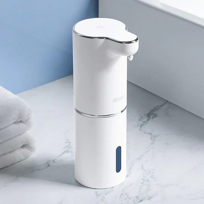 White soap dispenser on a marble countertop with a blue wall in the background